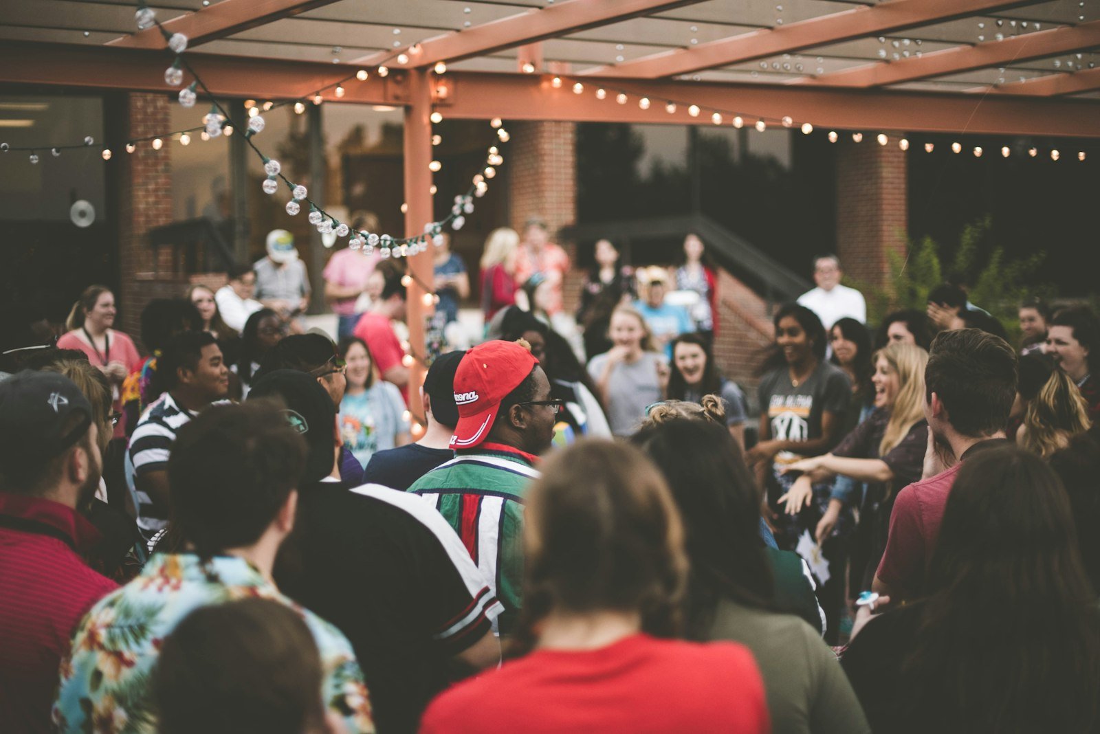 A warm community gathering under festival lights